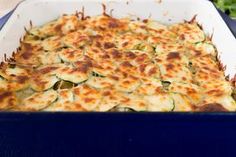 a casserole dish with zucchini and cheese in it on a table