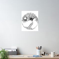 a black and white drawing of a tree on a wall above a desk with office supplies