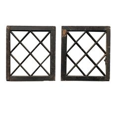 pair of antique iron window frames with square grids on each side, isolated against a white background