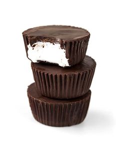 three chocolate cupcakes stacked on top of each other