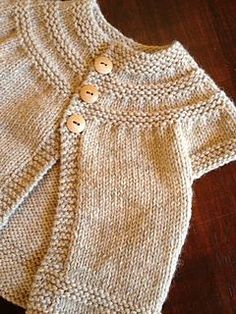 a knitted sweater with buttons on the front