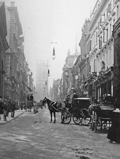 an old black and white photo of horse drawn carriages on a city street in the early 1900's