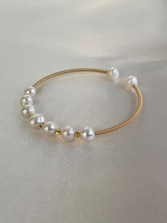 Genuine fresh water bangle with gold faceted beads gold color. Elegant Gold Bead Bangle, Elegant Gold Bangle With Round Beads, Elegant Gold Beaded Bangle, Adjustable Gold Plated Pearl Bangle, Gold Beaded Bangle Pearl Bracelet, Gold Beaded Pearl Bangle Bracelet, Gold Minimalist Bangle Pearl Bracelet, Gold Pearl Bangle Bracelet, Gold Pearl Bangle As Gift