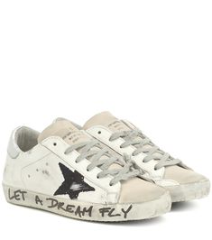 Golden Goose's classic Superstar sneakers arrive adorned with black stars and graffiti-style writing on the sole, making for a casual-cool update to your footwear edit. Crafted in Italy from faded white leather with beige accents, this design features the label's hallmark "worn" detailing that gives them a lived-in look. Team yours with your favorite day dress for an of-the-moment appearance.