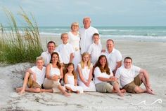 a family posing for a photo on the beach