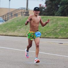 a shirtless man running on the street