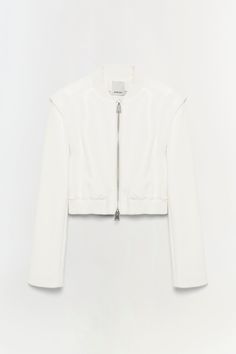 SIGNATURE COLLECTION The Doreen Jacket in Ivory. Structured bomber silhouette engineered in supple vegan leather. Cropped sportif waist. Chic Spring Biker Jacket With Padded Collar, Luxury Cropped Jacket For Spring, Chic White Leather Outerwear, Luxury White Spring Outerwear, Maxi Dress Wedding Guest, Swimwear Sets, Maxi Dress Wedding, Knitwear Tops, Cropped Jacket