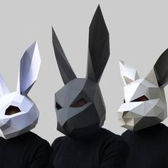 three people wearing paper masks with bunny ears on their head and one man in black shirt