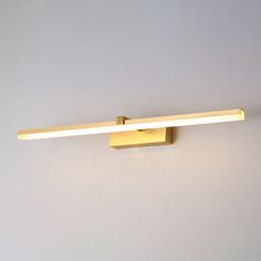 a light that is on the side of a wall with a white wall behind it