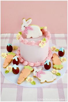 a decorated cake on a table with cookies