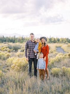 a family standing in the middle of a field