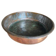 a large metal bowl on a white background