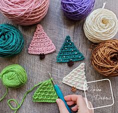 crochet christmas tree ornaments are being worked on by someone using yarn to make them