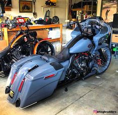 two motorcycles parked in a garage next to each other