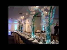 a long table with clear vases filled with balloons