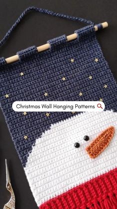 a crocheted bag with a snowman face on it