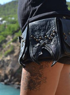 "Leather steampunk waist bag -black cow leather and sting ray waist bag three front side pocket with button: 2pocket 3inch x 5inch - 1pocket 4inch x 6inch one big front zip : 12inch x 5.5 one rear side secret pocket : 9 inch x 5.5 (mini tablet) -Sizes: size S: [31\" to 36\"] or [79 cm to 92 cm] size M: [33\" to 38\"] or [84 cm to 97 cm] size L: [36\" to 42\"] or [92 cm to 106 cm] size XL: [40\" to 46\"] or [101 cm to 116 cm] XXL and any other size made it to order Check all our Hip Belt on LEATH Leather Bags With Rivets For Alternative Fashion, Punk Leather Bag For Festivals, Alternative Style Black Bags For Festivals, Steampunk Leather Bag With Belt Loops, Leather Festival Bag With Belt Included, Festival Leather Bag With Belt Included, Black Belt Bag With Pockets For Festival, Black Belted Bag For Festival, Black Belt Bag With Adjustable Strap For Festivals