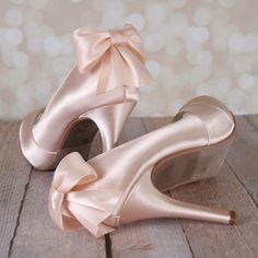 a pair of pink high heeled shoes with a bow