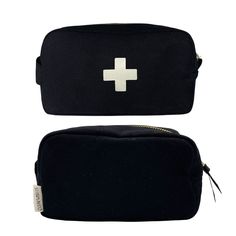 two black bags with white crosses on the front and one has a zippered pouch