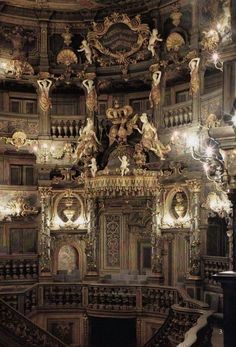 an ornately decorated room with chandeliers and statues