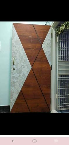 an image of a door that is made out of wood and marble with metal bars on it