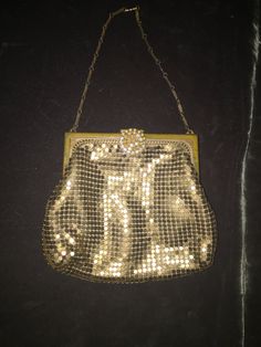 "Small and attractive gold metal mesh authentic 1920's Whiting & Davis evening bag with rhinestone clasp and sold brass frame. The jewelry style chain makes this bag unique. Rhinestone clasp is missing a few stones (see link below for rhinestone replacement) Beautiful peach satin lining is in good condition. Wonderful dancing bag to hold theater tickets, lipstick and compact mirror. Whiting & Davis has been joining little metal tiles into shimmering sheets of possibility since 1876. Fash Gold Evening Jewelry With Clasp, Gold Jewelry With Clasp For Evening, Vintage Party Jewelry With Chain Strap, Victorian Rectangular Evening Bag For Party, Gold Metal Evening Bag With Chain Strap, Vintage Gold Jewelry For Evening, Vintage Gold Bag With Chain Strap, Vintage Gold Bags With Chain Strap, Victorian Gold Bag As Gift