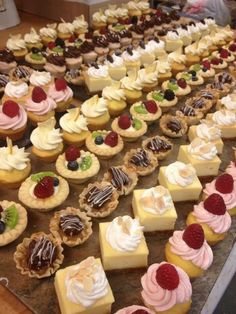 a table topped with lots of desserts and pastries on top of each other