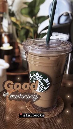 a starbucks drink sitting on top of a wooden table