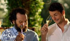 two men holding wine glasses and looking at each other with the words the wine show written on them