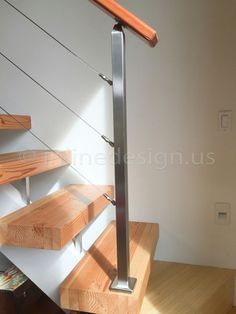 a wooden stair case with metal handrails and wood treading on the bottom