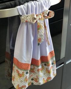 a kitchen towel hanging from the handle of an oven