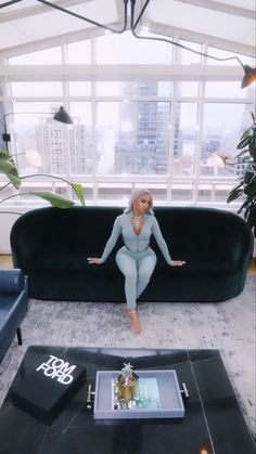 a woman sitting on top of a couch in a living room