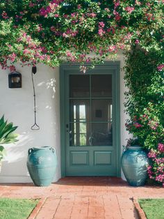 a house with flowers growing over the front door and side entry way to another home