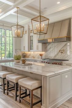 a large kitchen with marble counter tops and white cabinetry, along with four stools