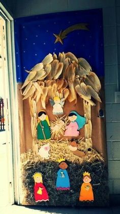 a nativity scene is displayed on the front door