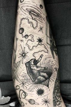 a man's arm with an astronaut tattoo on it