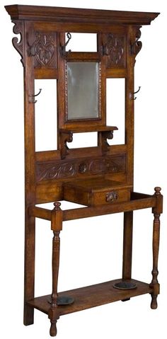 an old wooden shelf with mirror on it's top and shelves below the shelf