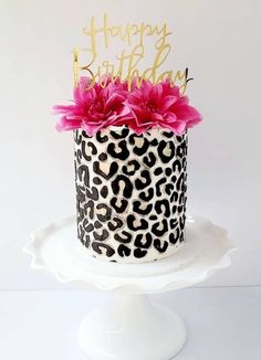 a leopard print birthday cake with pink flowers