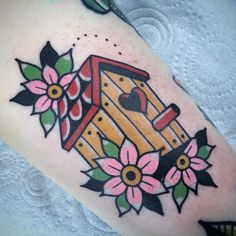 a birdhouse with flowers and hearts on it's side tattoo by the artist