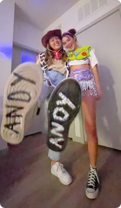 two young women are posing with their skateboards