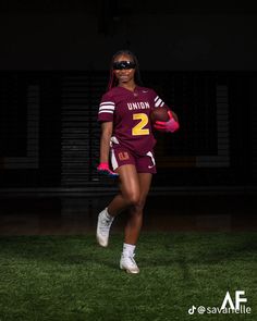 a female football player is running in the dark