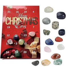 a christmas card surrounded by rocks and other holiday decorations, with the words merry christmas on it