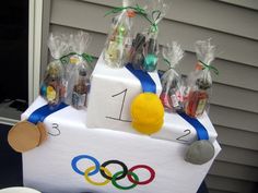 an olympic themed cake with candy and candies in bags on the side of it