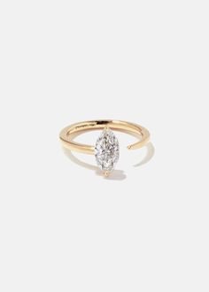 a yellow gold ring with a single diamond