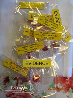 several pieces of candy wrapped in cellophane with yellow stickers reading evidence on them