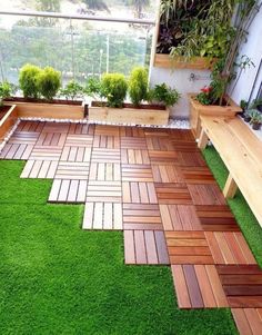 an outdoor area with grass and wooden benches