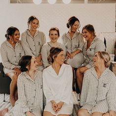 a group of women sitting next to each other in pajamas