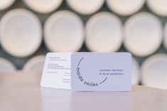 a white business card sitting on top of a table