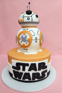 a star wars themed cake with a robot on it's top and the words,