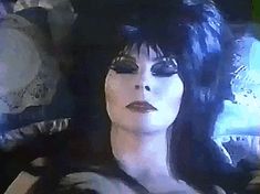 a close up of a person with black hair and make - up on their face